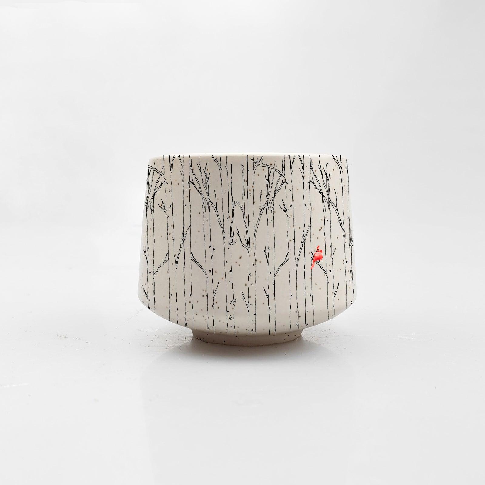 The Mini Aspen and Cardinal Cup by Artsy Ems Designs is a white ceramic cup featuring thin black branch-like lines and a small red bird, ideal as an espresso cup or succulent planter, shown against a plain white background.