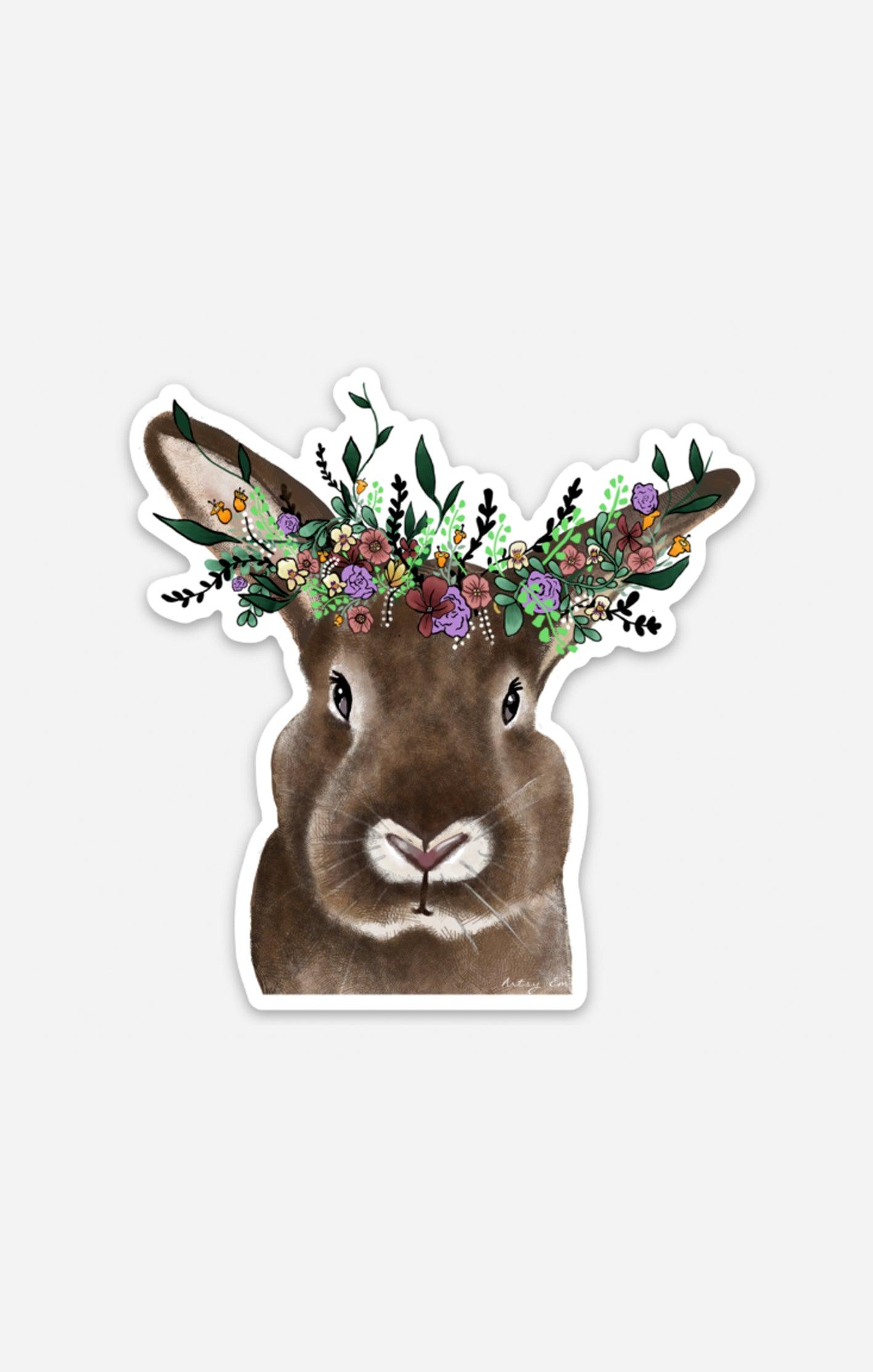 Hand-drawn bunny sticker featuring realistic fur and a colorful floral crown with purple, pink, and green flowers, designed by Artsy Em’s Designs.